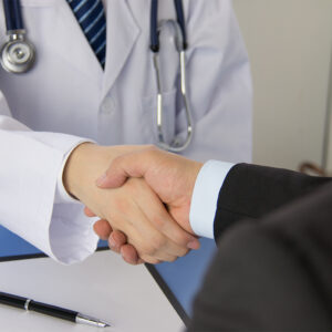 Doctor and businessman shaking hands Doctor and businessman shaking hands